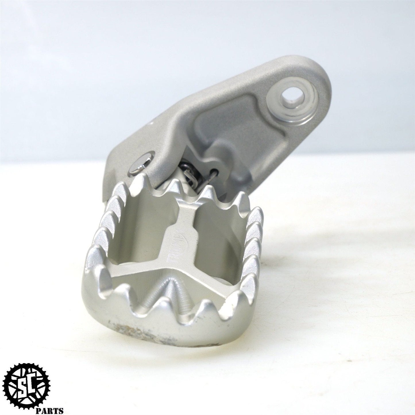 22-23 TRIUMPH TIGER 1200 LEFT FRONT FOOT PEG BRACKET T25
