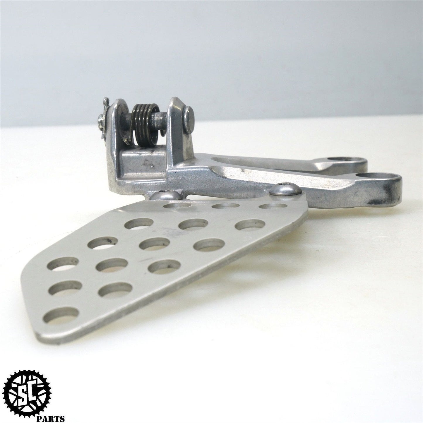 2004 HONDA CBR1000RR LEFT REARSET FOOT PEG BRACKET H24